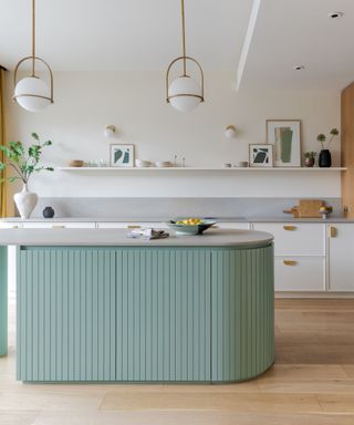 White and green kitchen with pale green kitchen island, concrete wortop,