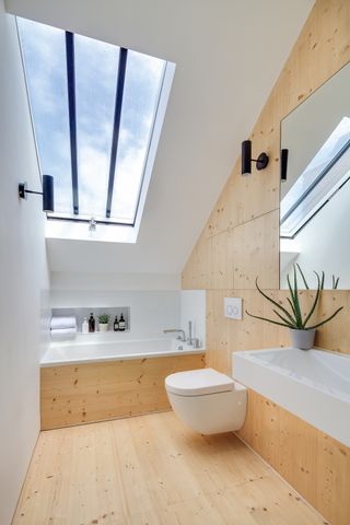 plywood wall panelling in modern bathroom with rooflight