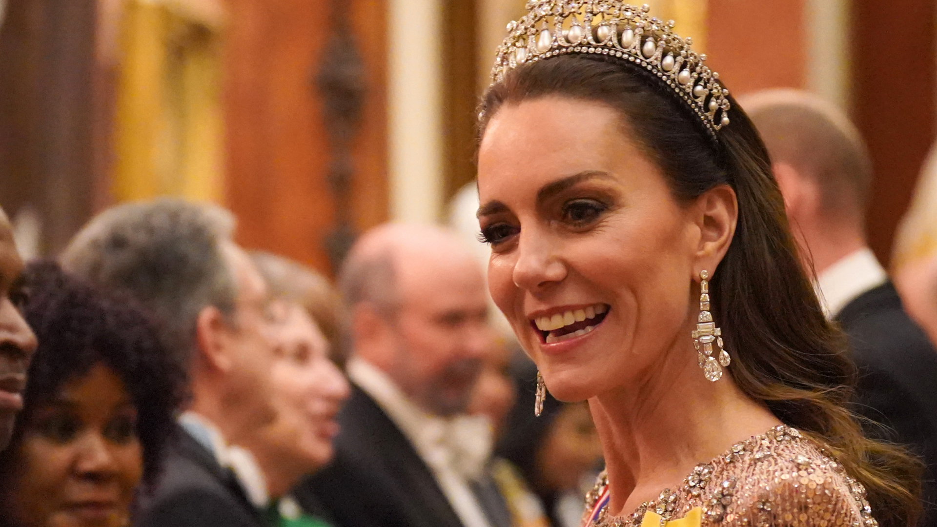 Kate Middleton wearing a tiara and a pink sequined gown