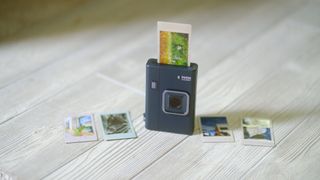 The Instax Mini LiPlay+ on a white wood background