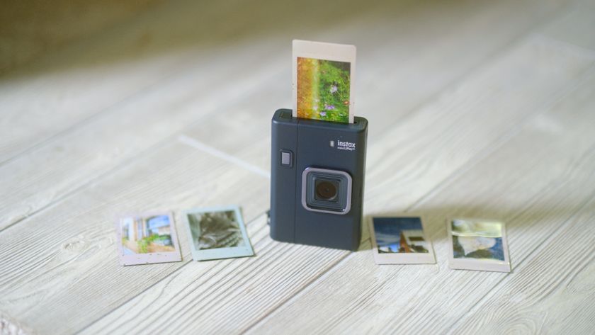 The Instax Mini LiPlay+ on a white wood background