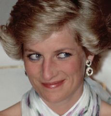 Princess diana smirking and wearing diamond earrings