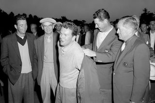 ack Burke receives his Green Jacket from Cary Middlecoff after the 1956 Masters Tournament GettyImages-82742748