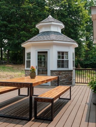 an outdoor deck with an outhouse