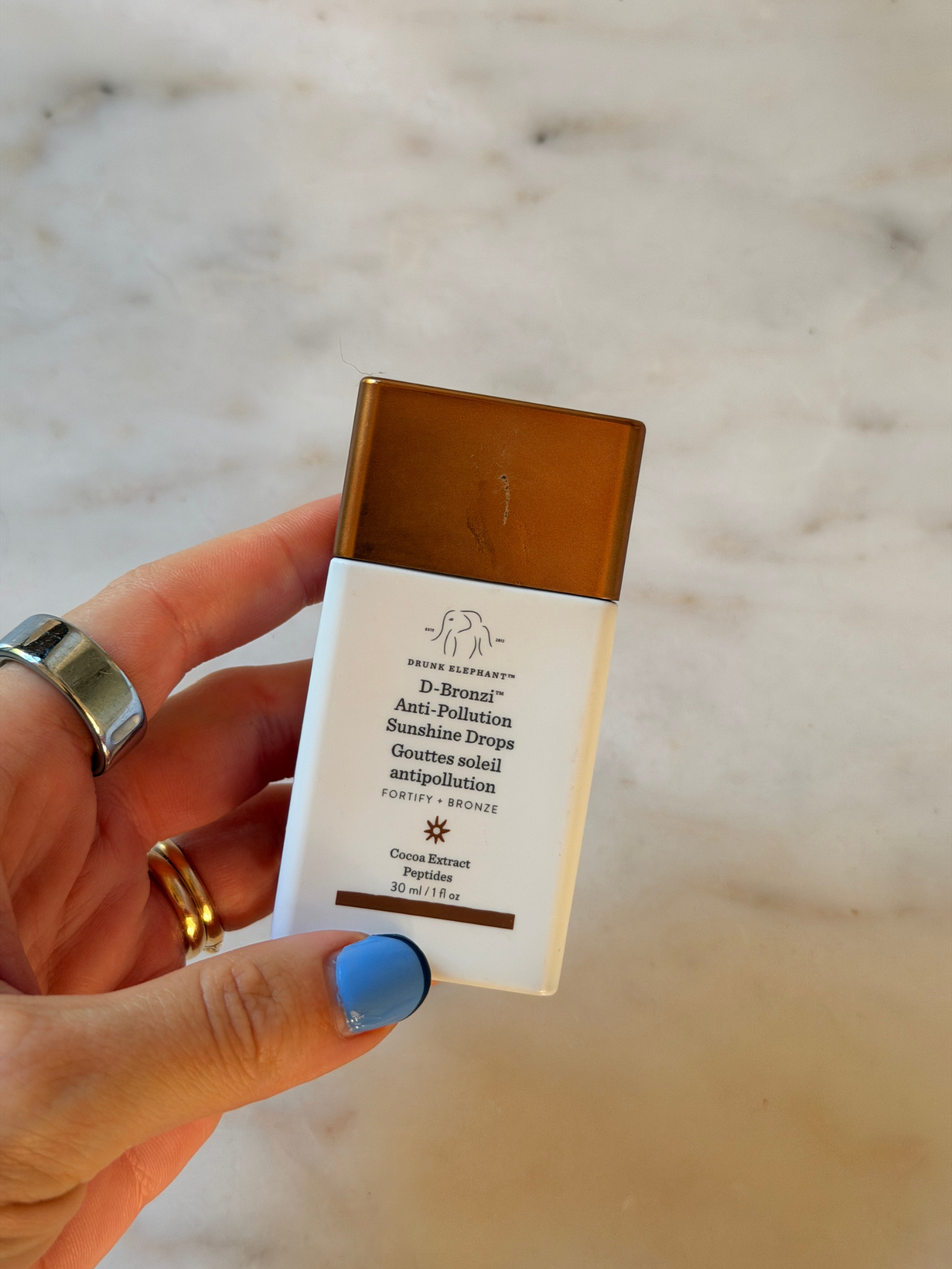 Freelance beauty editor Grace Day holding the Drunk Elephant primer.