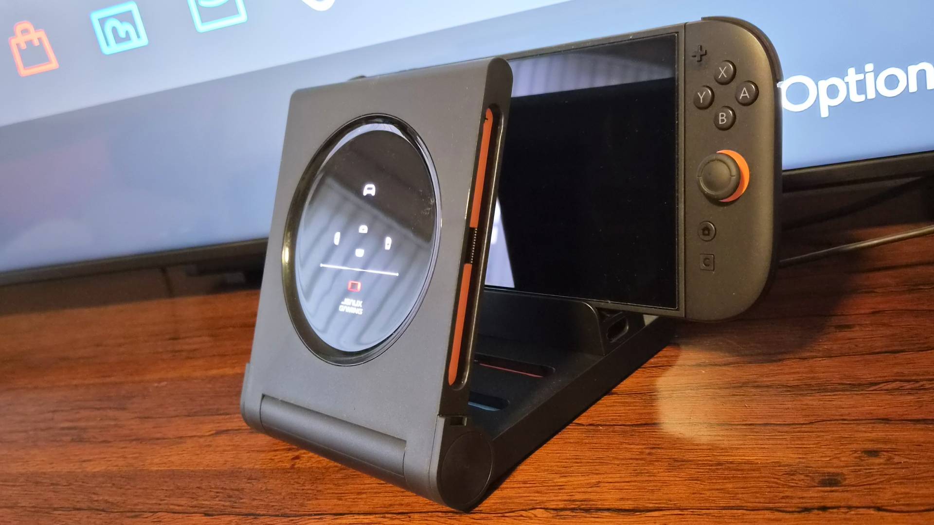 Photo of the JSAUX 6-in-1 Gaming Dock for the Switch 2 sitting in front of a TV.