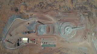 Overhead view of the Giant Magellan Telescope site in mid-March 2019. Excavation for the pier and enclosure foundations is complete. Trenching work for the upgraded water and electrical distribution systems can be seen at the top of the image.