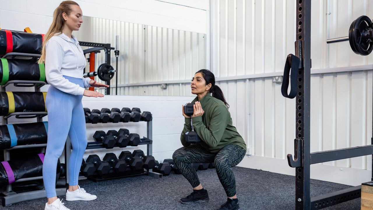 A woman performing a goblet squat 