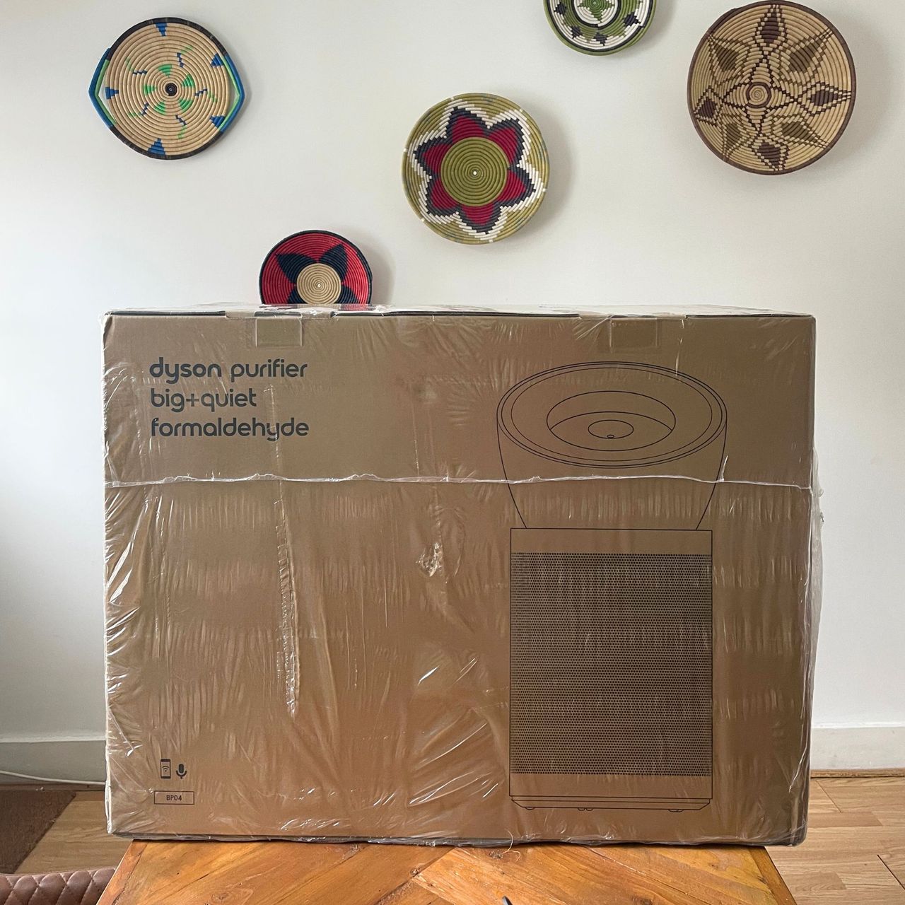 Dyson Purifier Big+Quiet Formaldehyde box on a wooden table in front of a white wall