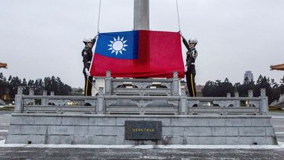 Honour guards prepare to raise the Taiwan flag in the Chiang Kai-shek Memorial Hall square