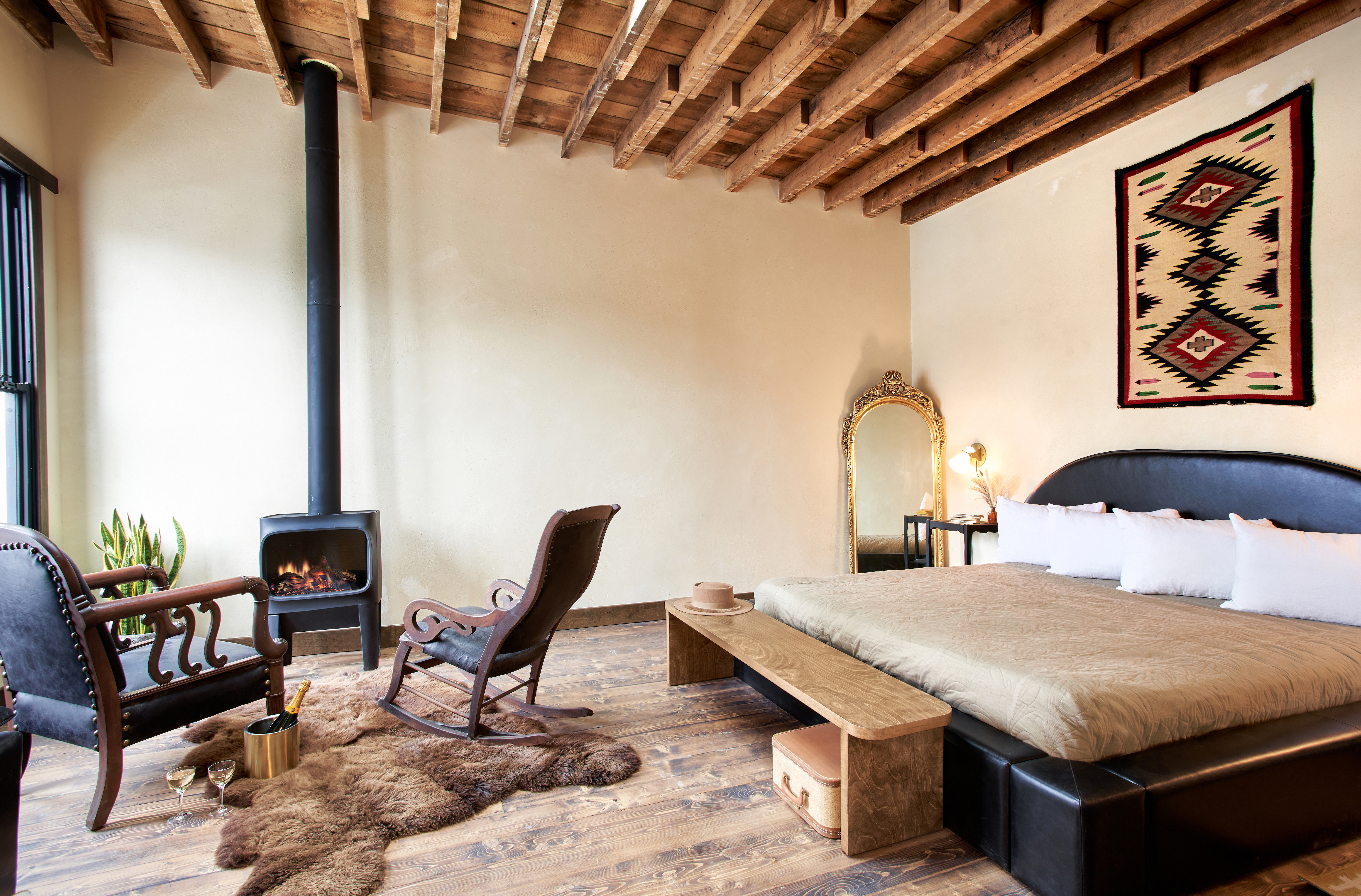 A bedroom with a gas fireplace in The Western Hotel