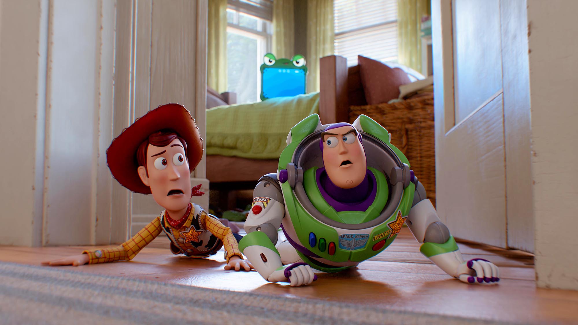 Woody and Buzz lying on the floor and looking at each other in Toy Story 5