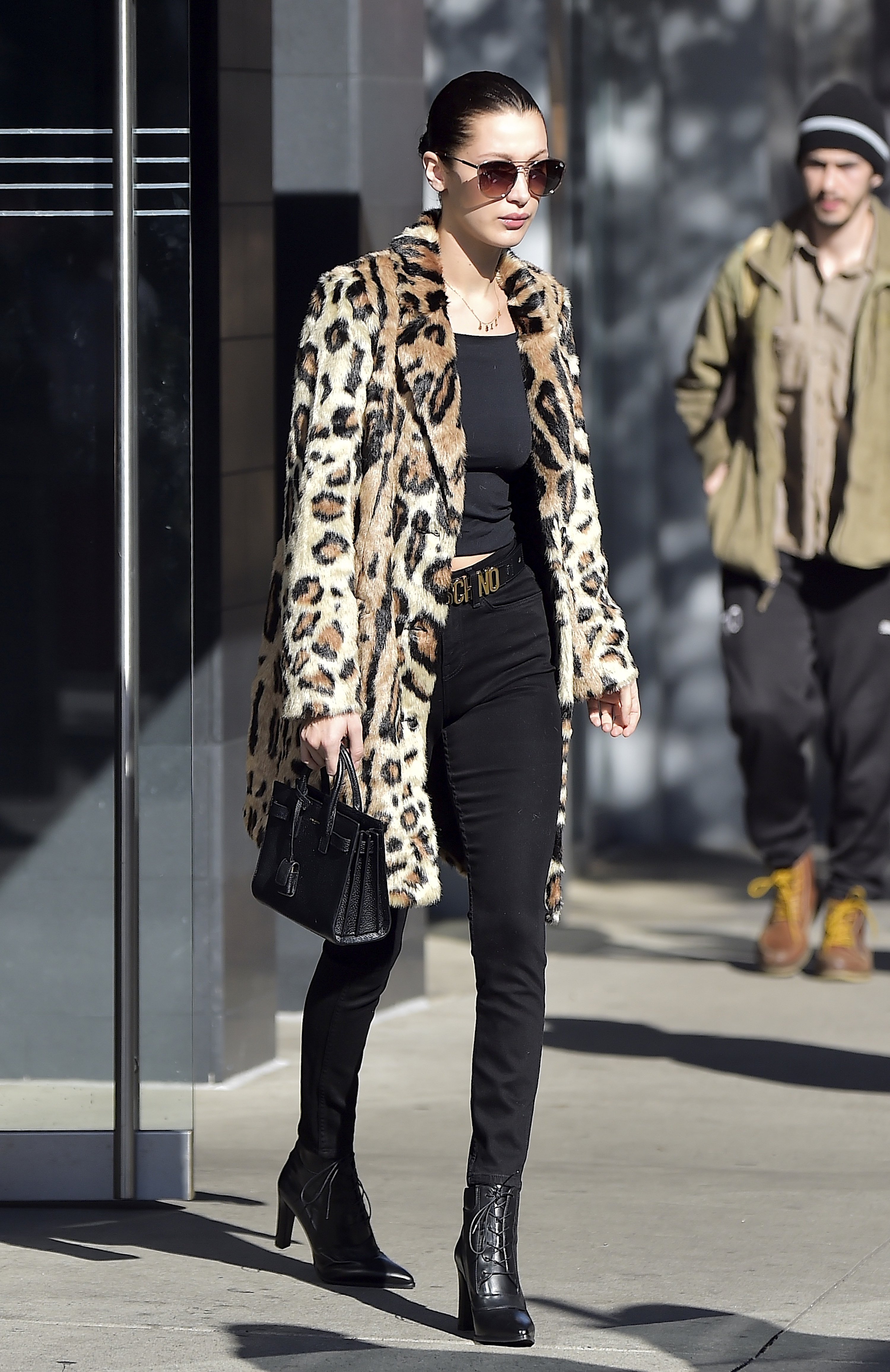 An image of Bella Hadid wearing a leopard print coat while out in New York in 2016.
