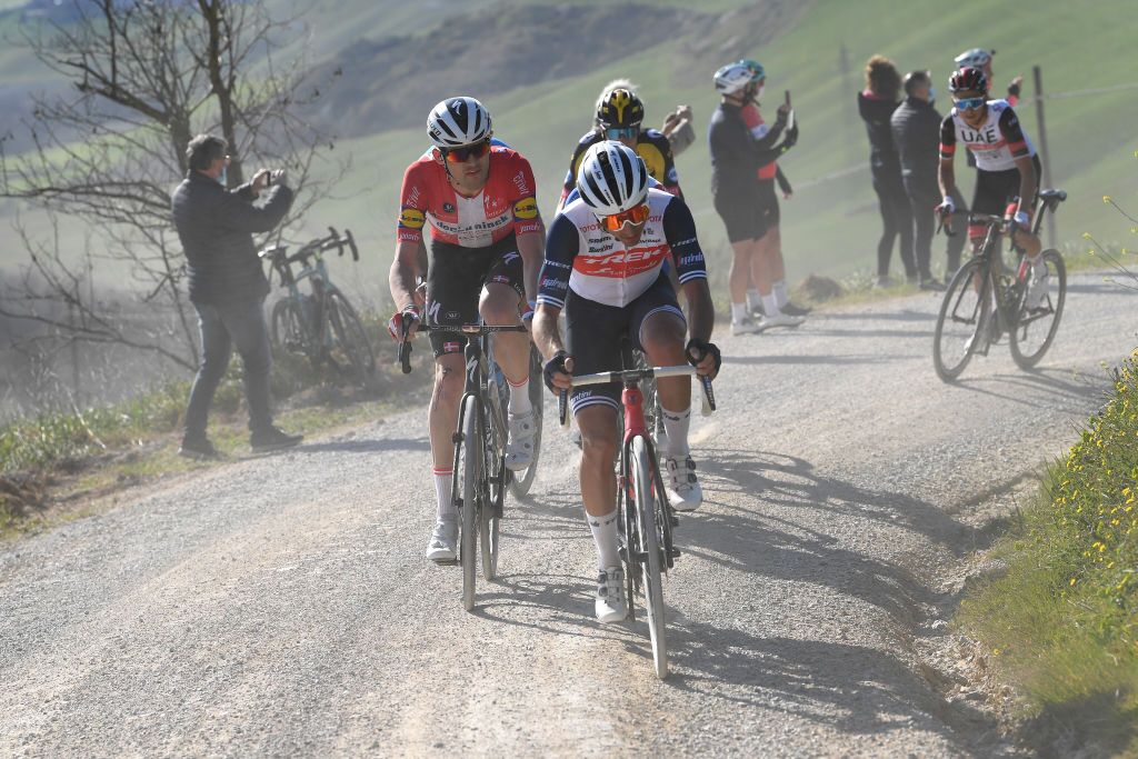 SIENA ITALY MARCH 06 Kasper Asgreen of Denmark and Team Deceuninck QuickStep Gianluca Brambilla of Italy and Team Trek Segafredo during the Eroica 15th Strade Bianche 2021 Mens Elite a 184km race from Siena to Siena Piazza del Campo Breakaway Gravel Strokes Dust StradeBianche on March 06 2021 in Siena Italy Photo by Tim de WaeleGetty Images
