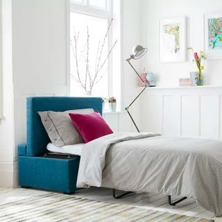 A blue bed in a box with pull-out mattress