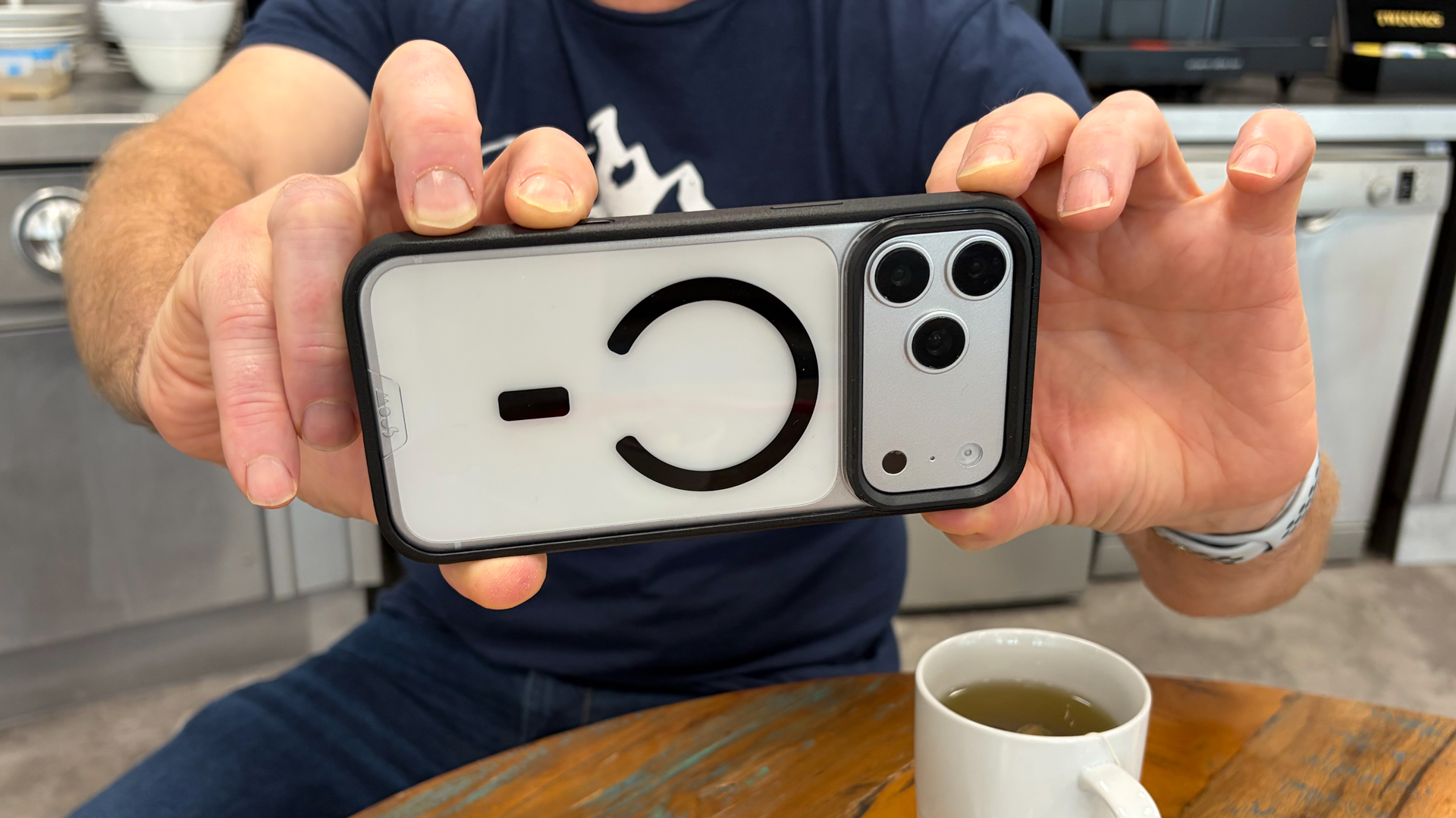 Person using an iPhone 18 Pro Max in a Mous Clarity case