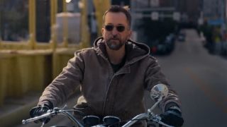 Noah Wyle as Robby riding a motorcycle and not wearing a helmet. 