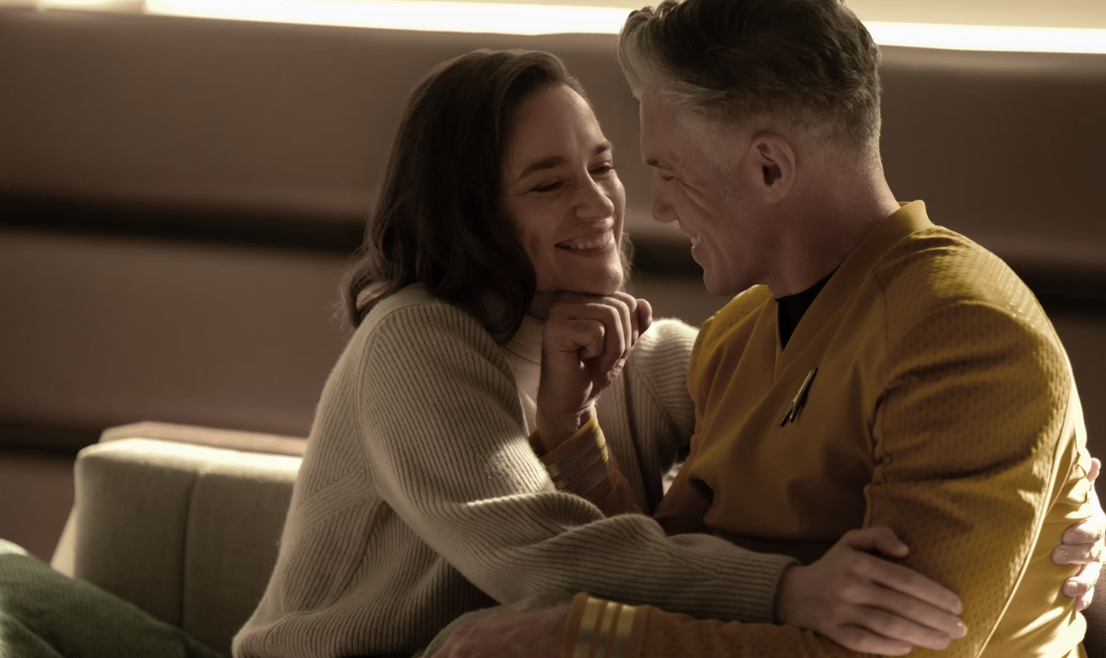 a woman and a man sharing a romantic moment together on a spaceship