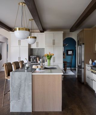 Modern kitchen by Truss with a modern rustic waterfall island in stone and wood photograph by Emily Minton Redfield