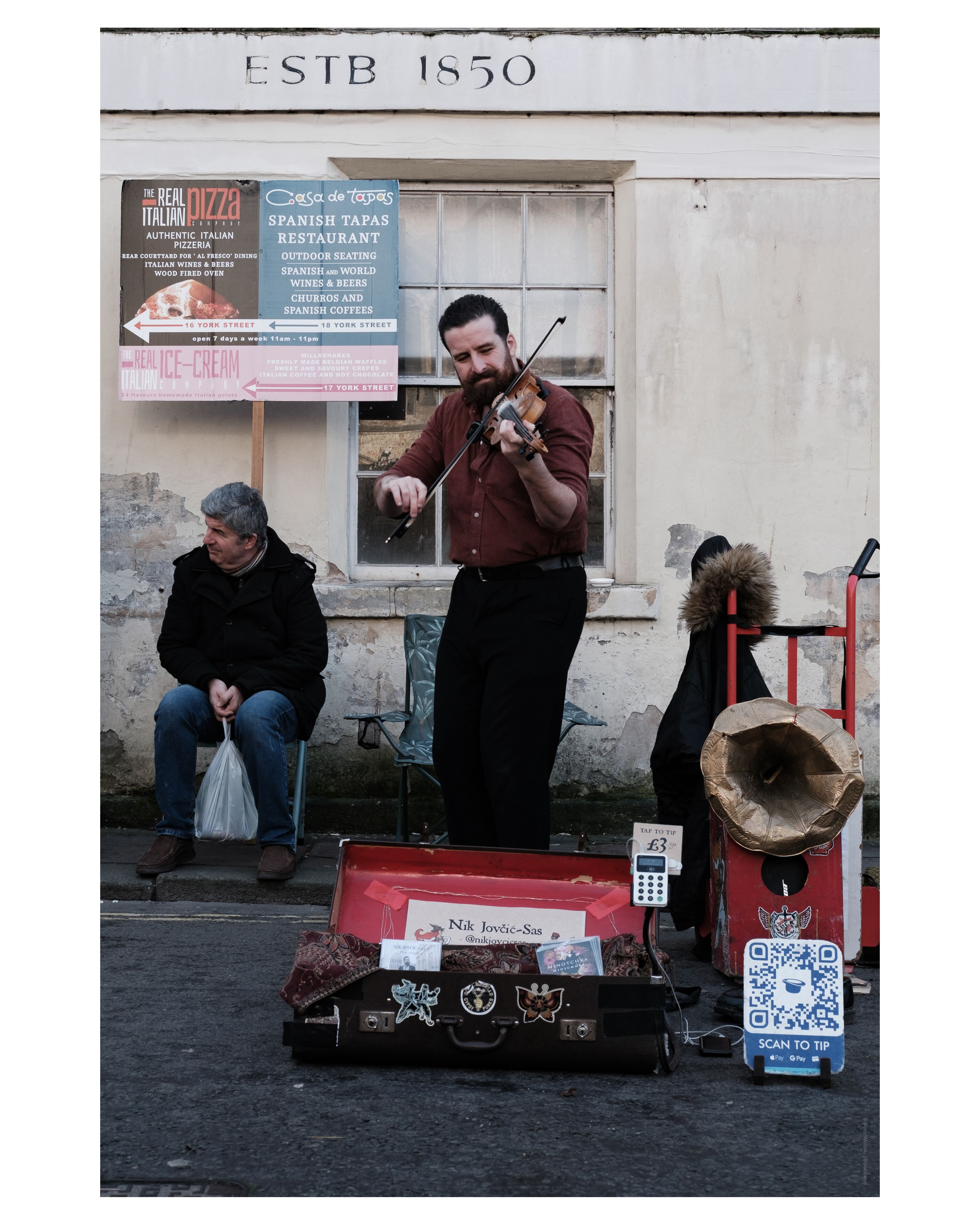 A photo of a man playing the violin