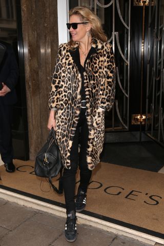 Kate Moss wearing a leopard print coat and Adidas Samba trainers