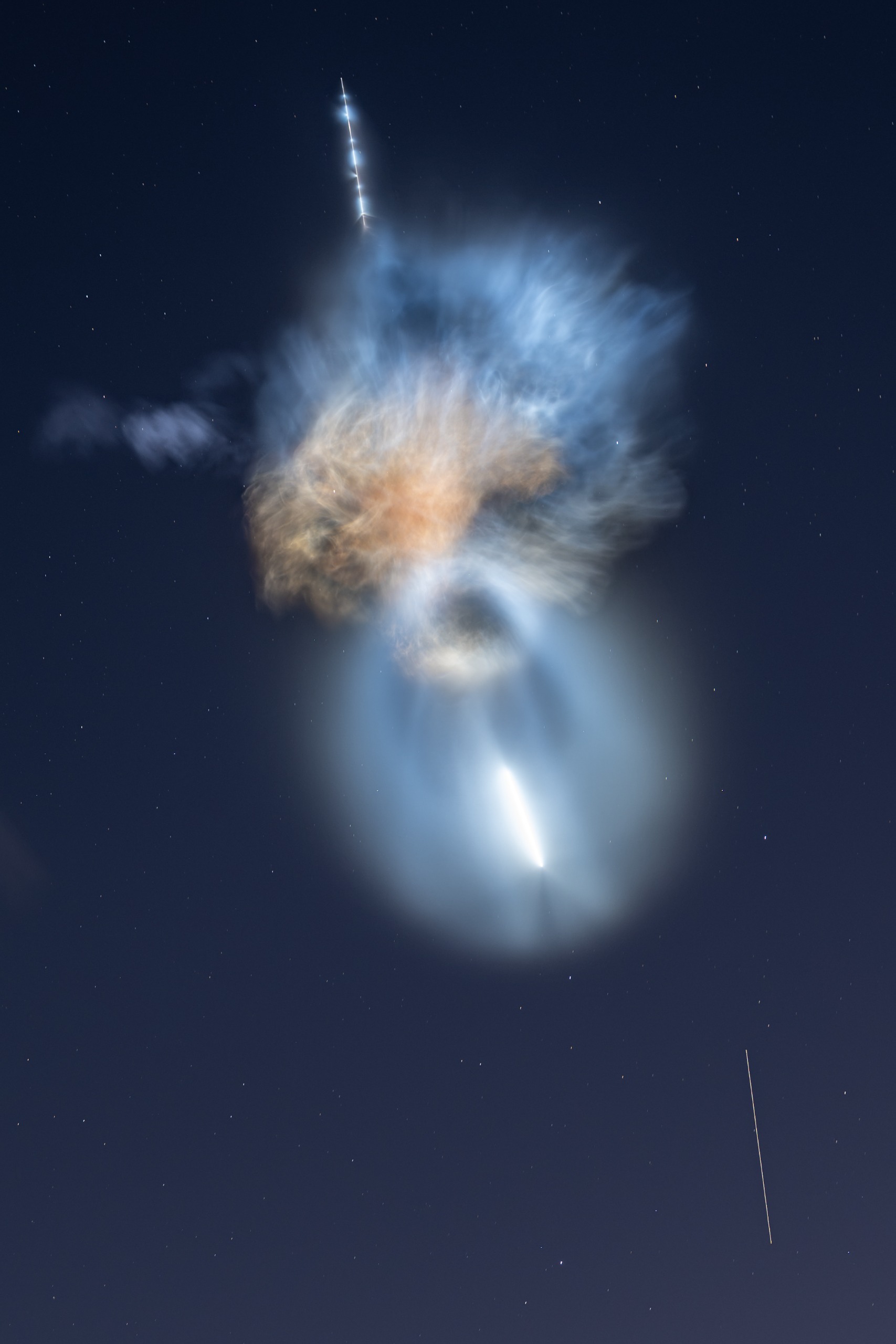 Sunlight hitting exhaust plumes from a SpaceX rocket creates an unusual shape in the sky