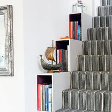 staircase side space used as bookshelves is interesting design