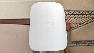 An Eero Outdoor 7 mesh extender mounted to a pole