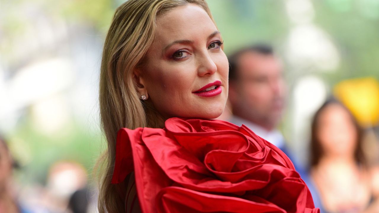 kate hudson posing in red dress