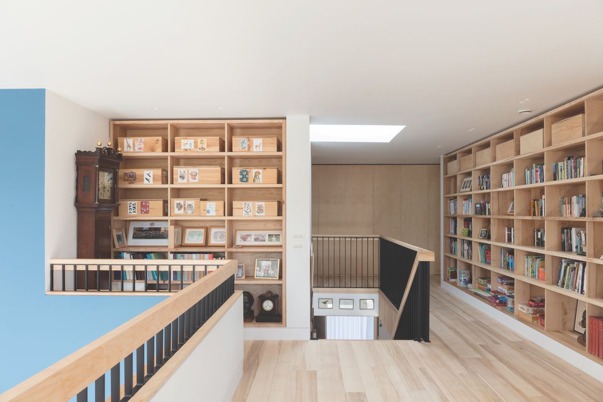 timber cladding in bright hallway with built in bookshelves