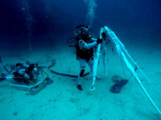 NASA astronaut Kjell Lindgren unfolding the Lunar Evacuation System Assembly so he can come to ESA astronaut Pedro Duque's aid in a simulated lunar rescue.