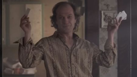 Buffalo Bill holding up a lot of cards in both hands in The Silence of the Lambs. 