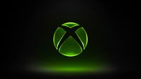 Image of the green Xbox logo set on a mostly dark background with green lights below the logo.