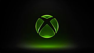 Image of the green Xbox logo set on a mostly dark background with green lights below the logo.