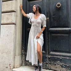 @vivian.yrl wearing white dress and solomon sneakers