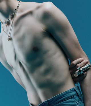 model's bare chest, with SweetLimeJuice necklaces and finger jewellery in view