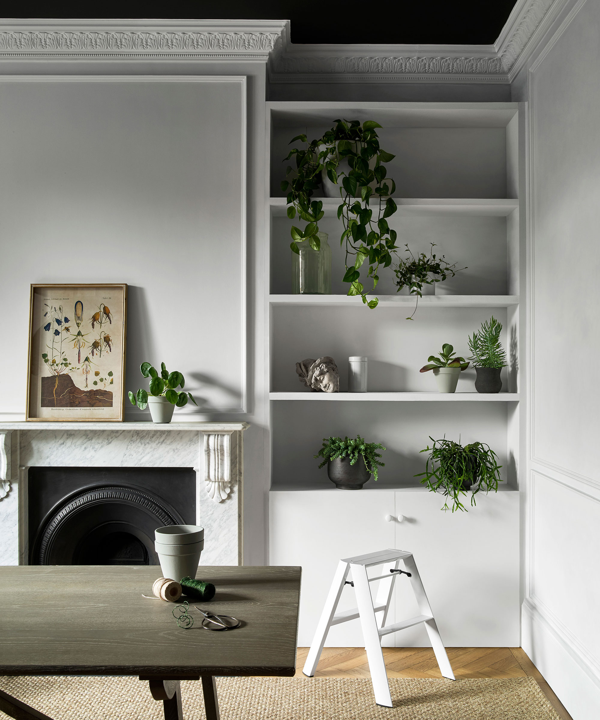 White painted dining room with shelves built in alcove and cornicing details on coving