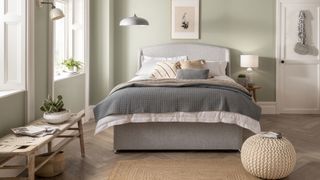 Silentnight Sleep Healthy mattress on a grey bed frame and dressed with beige and grey linens and throws