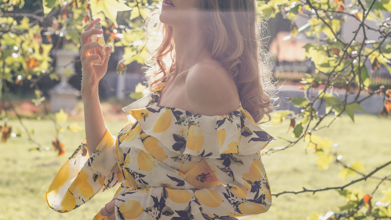 Girl spraying sustainable fragrance