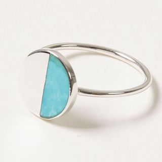 The Lyca Semi Circle Turquoise & Silver Ring pictured on a neutral background