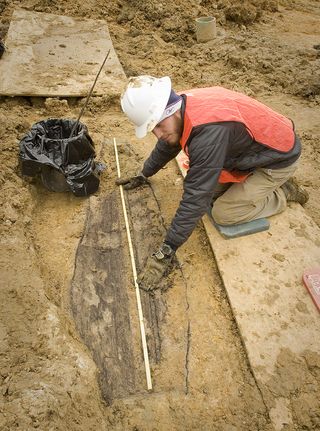 James Roncki of Tennessee Valley Archaeological Research measures the length of a coffin found at the site of the former state psychiatric hospital.