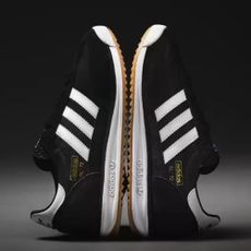 Pair of black and white Adidas SL-72 trainers on gradient grey-black background