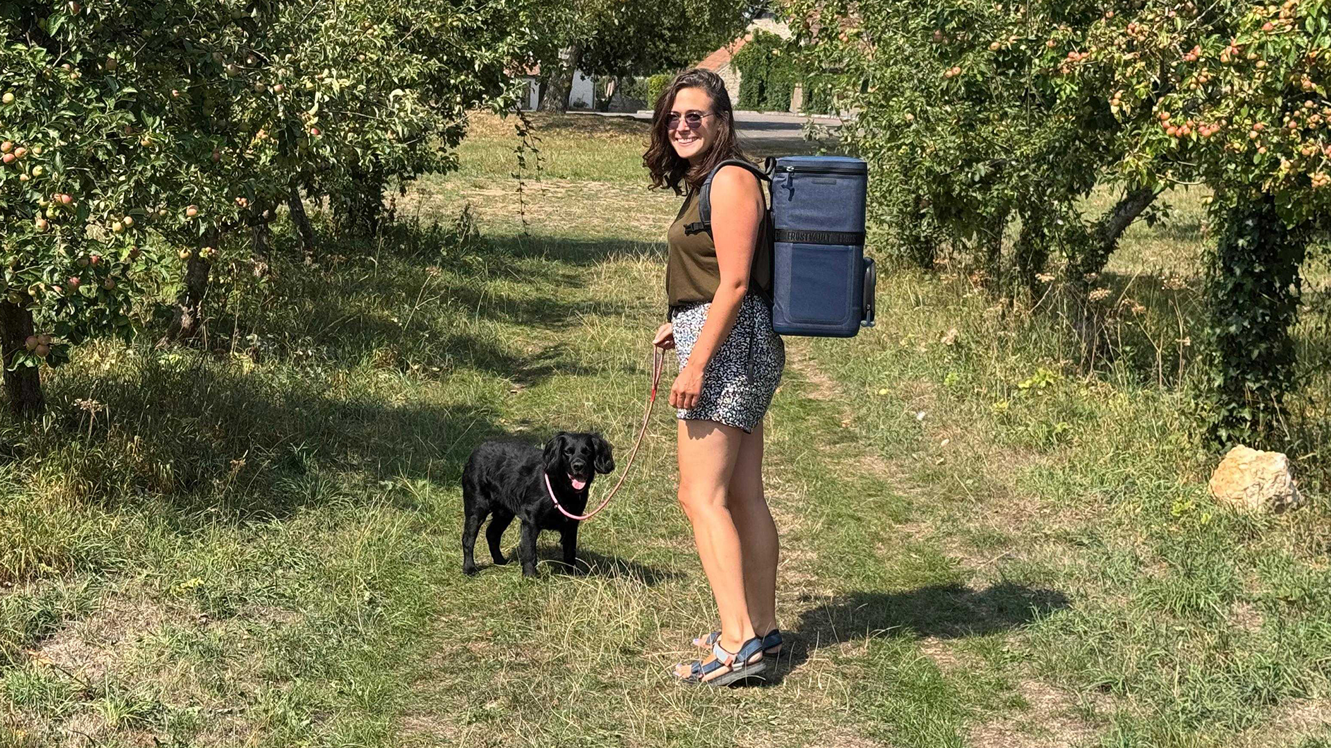Writer wearing Ninja FrostVault Go while walking through an orchard