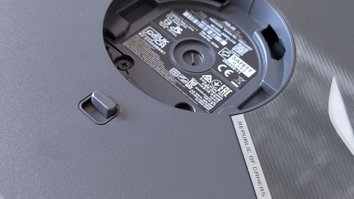 Underside of the ASUS ROG monitor stand mount displaying certification labels and product markings.