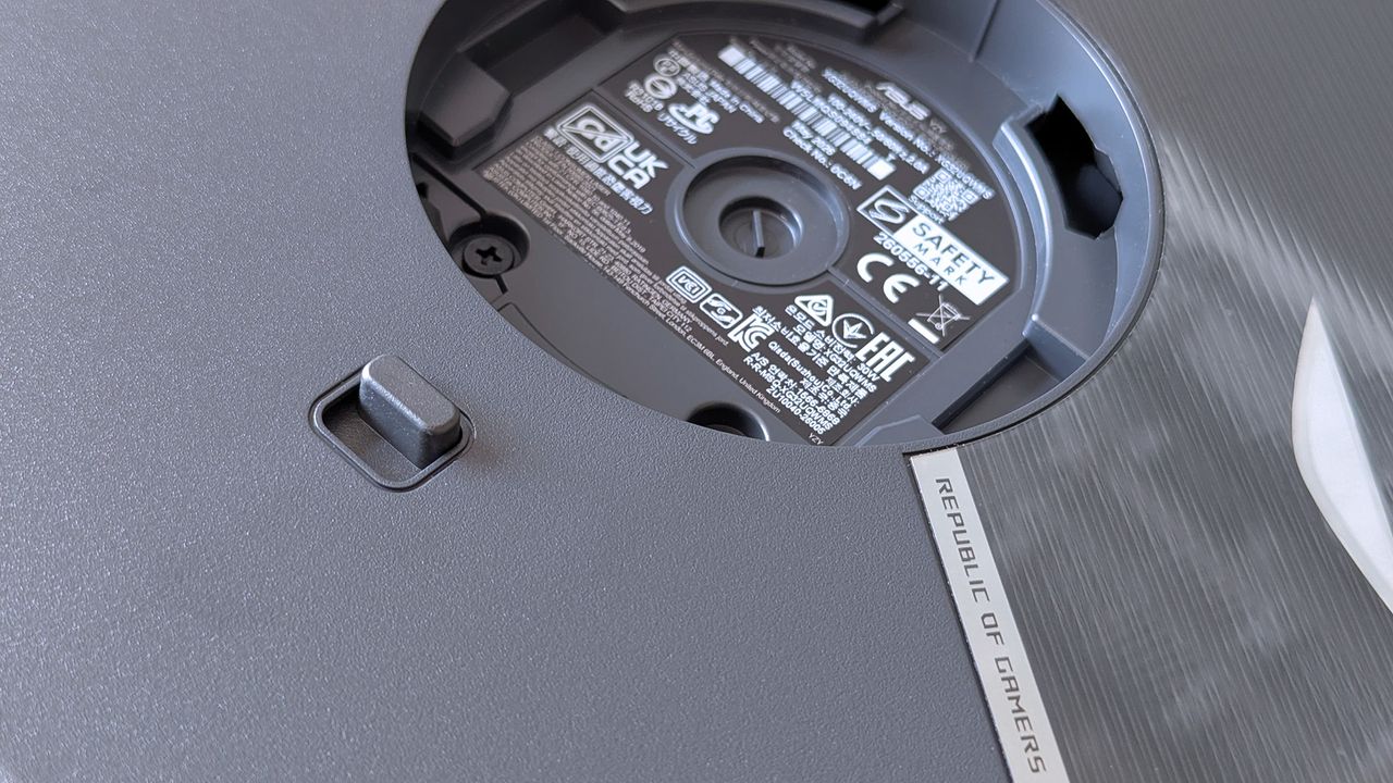 Underside of the ASUS ROG monitor stand mount displaying certification labels and product markings.