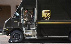 A photo of a UPS driver inside their truck