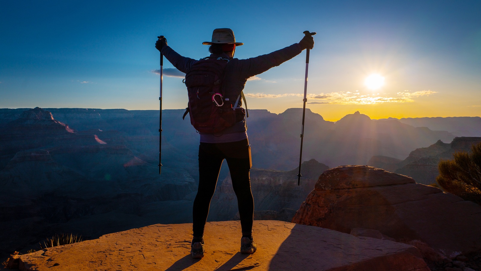 Female hiker enjoying the sunrise on the South Kaibab trail of the Grand Canyon.