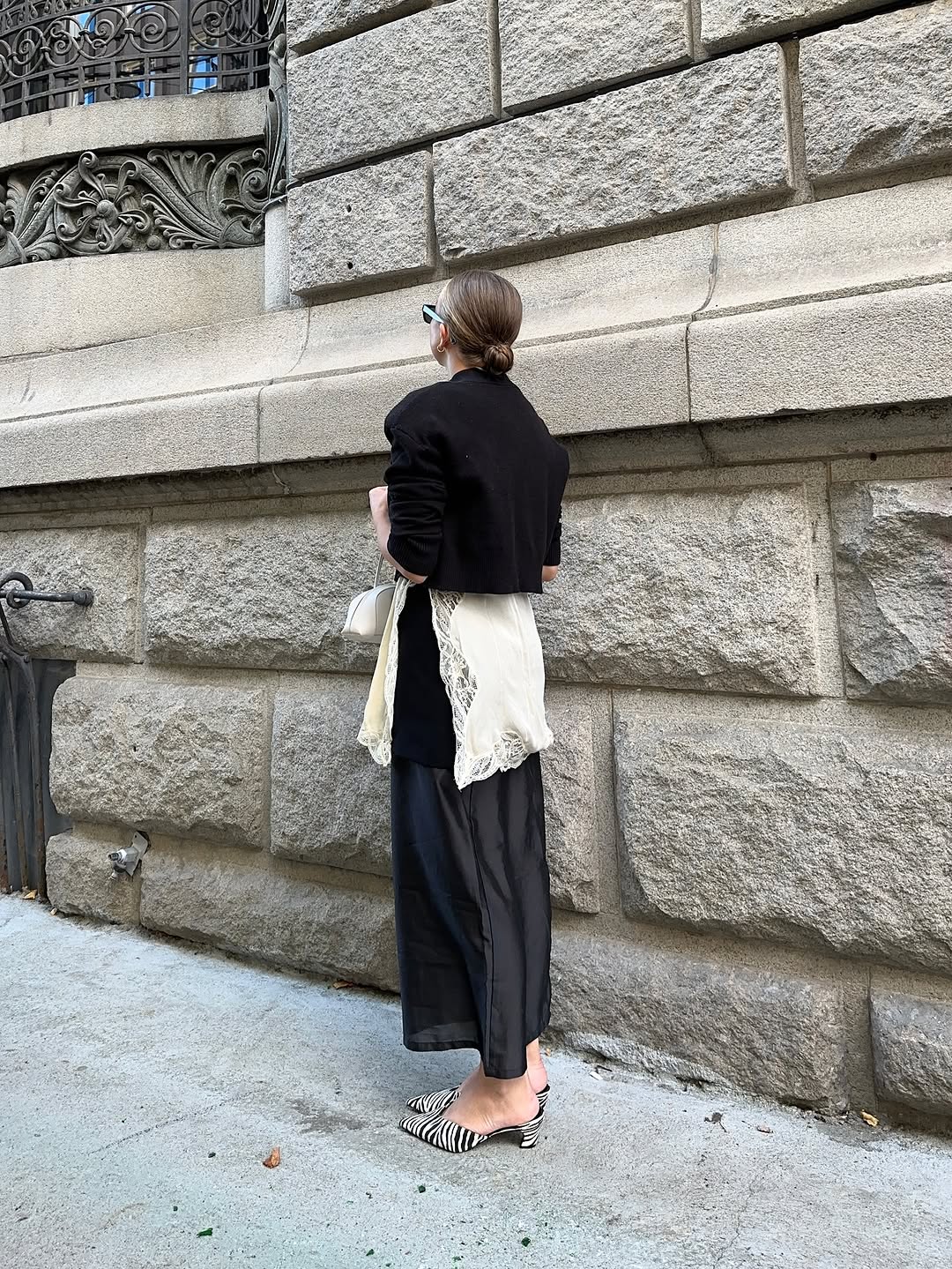 woman wearing dress over pants fall outfit 2025