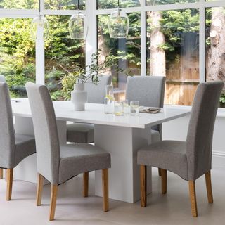 dining room with white dining table and grey dining chairs