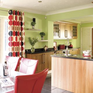 kitchen with red chair and green wall combination